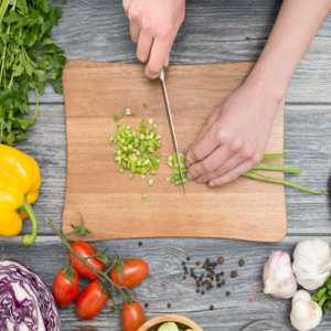 chopping vegetables on a wood cutting board