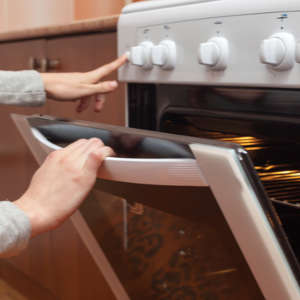 woman opening oven door