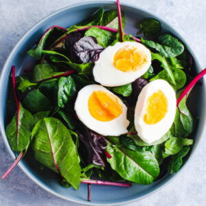 greens topped with hard boiled egg