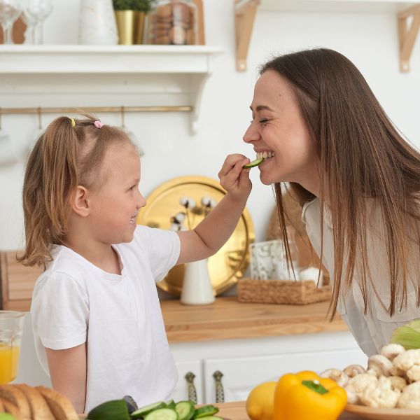 mom and daughter preparing a salad